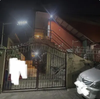 a gate in front of a building at night at Cozy Hideout-Free Parking, Netflix & Arcade Games in Cainta