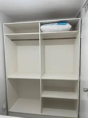 a white refrigerator with empty shelves in it at Cozy Hideout-Free Parking, Netflix & Arcade Games in Cainta