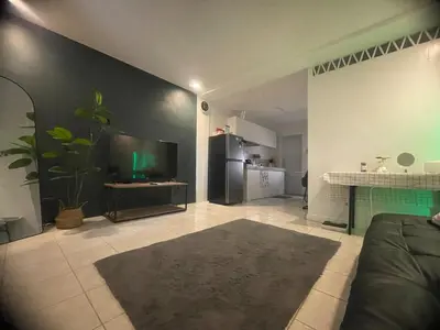 a living room with a couch and a tv at Cozy Hideout-Free Parking, Netflix & Arcade Games in Cainta