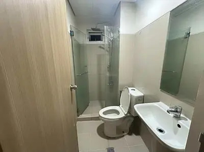 a bathroom with a shower and a toilet and a sink at Family room Staycation Near MOA in Manila