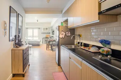 a kitchen with a sink and a counter top at Two Maridien 41stFlr Studio -Minimalist Functional in Manila