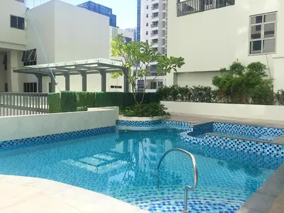 a swimming pool in the middle of a building at Two Maridien 41stFlr Studio -Minimalist Functional in Manila