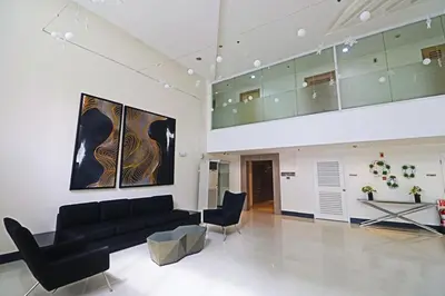 a living room with a black couch and chairs at A Comfy Self-Check-In and Check-out 1BR Light Residences in Manila