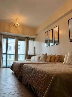 a large bed in a bedroom with a large window at 81NB Cozy Studio -City View, 2 Queen Beds, NAIA T3 in Manila