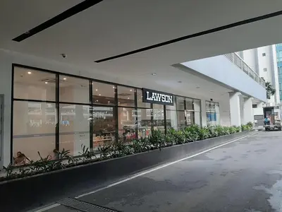a large building with a sign on the front of it at 81NB Cozy Studio -City View, 2 Queen Beds, NAIA T3 in Manila