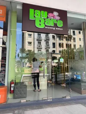 a woman is looking in the window of a store at 81NB Cozy Studio -City View, 2 Queen Beds, NAIA T3 in Manila