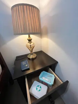 a table with a lamp and a box on it at Marvinn's by LVH - 150 Newport Boulevard in Manila