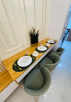 a long table with chairs and plates on it at The Haven Suite Shore3 Residences T2 in Manila