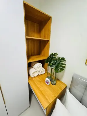 a table with towels and a plant in a room at The Haven Suite Shore3 Residences T2 in Manila
