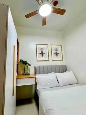 a bedroom with a bed and a ceiling fan at The Haven Suite Shore3 Residences T2 in Manila