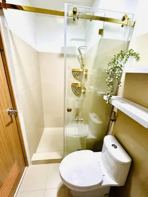 a bathroom with a toilet and a shower at The Haven Suite Shore3 Residences T2 in Manila