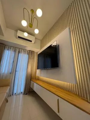 a living room with a flat screen tv on a wall at The Haven Suite Shore3 Residences T2 in Manila