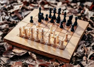 a wooden chess board with chess pieces on it at RED LUXE HAVEN Comfy stay, Netflix and Fast WiFi Ready in Manila