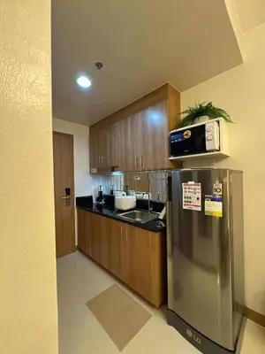 a kitchen with a stainless steel refrigerator and a microwave at RED LUXE HAVEN Comfy stay, Netflix and Fast WiFi Ready in Manila