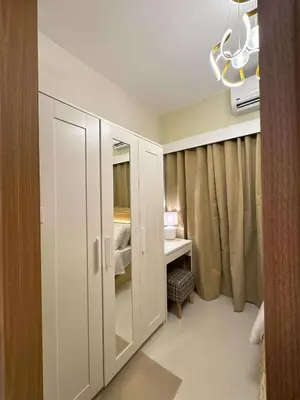 a room with a closet with a desk and a bedroom at RED LUXE HAVEN Comfy stay, Netflix and Fast WiFi Ready in Manila