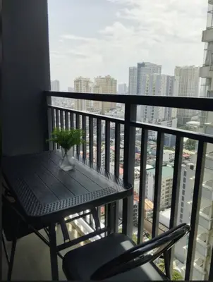 a balcony with a table and a chair on a balcony at RED LUXE HAVEN Comfy stay, Netflix and Fast WiFi Ready in Manila