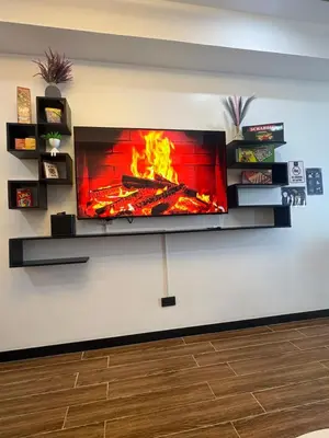 a fireplace with a fire in the wall at Sybay suites near okada MOA airport NAIA COD Manila MSV1806H in Manila