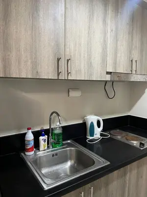 a kitchen counter top with a sink and a counter top at 1 bedroom condo unit near MOA in Manila