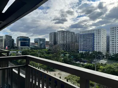 a view of a city skyline from a balcony at 1 bedroom condo unit near MOA in Manila