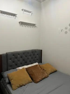 a bedroom with a bed with two pillows on it at 1 bedroom condo unit near MOA in Manila