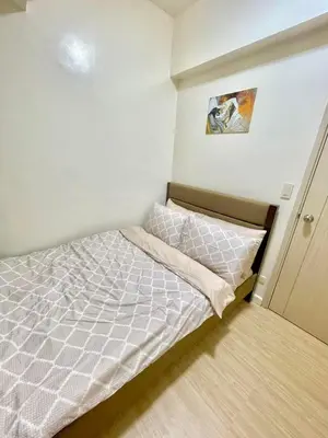a small bedroom with a bed in the corner at Cityscape Stays in Manila