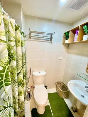 a bathroom with a toilet and a sink at Cityscape Stays in Manila