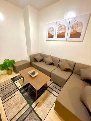 a living room with a couch and a coffee table at Cityscape Stays in Manila