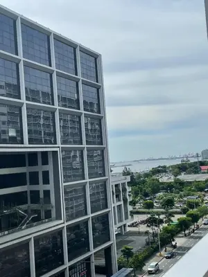 an office building with a view of a city at Minimalist Flat Retreat- Shore Residences in Manila