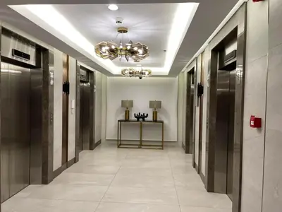 a hallway in a building with a chandelier at Green 2 Residences Tower1 unit 512 in Dasmariñas
