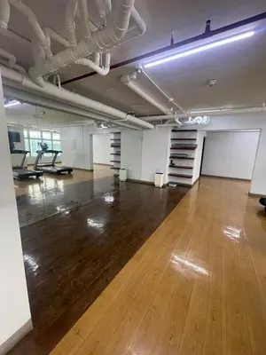 an empty room with a wooden floor and white walls at Antel Spa Residences 9A in Manila