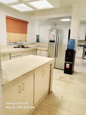 a kitchen with a refrigerator and a counter top at Majesty Suites in Manila