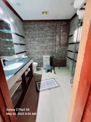 a bathroom with a sink and a shower at Majesty Suites in Manila