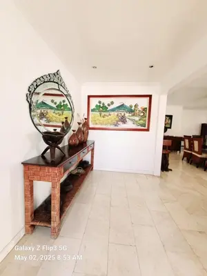 a living room with a mirror on a table at Majesty Suites in Manila