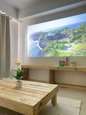 a room with a projection screen on the wall at Cozy Room in Modern Paraaque Condo with 2 Bedrooms in Manila