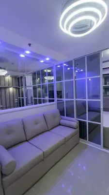 a living room with a couch and a circular ceiling at E&T staycation in Manila