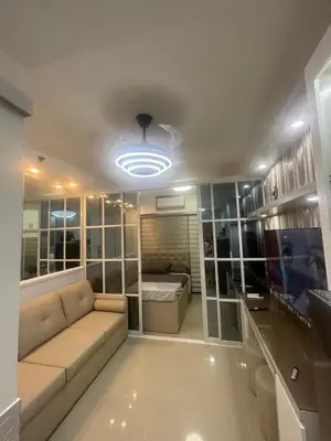 a living room with a couch and a bed at E&T staycation in Manila