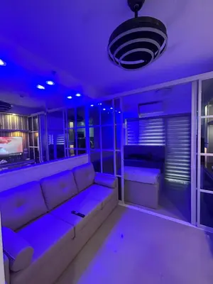 a living room with a couch in a purple room at E&T staycation in Manila