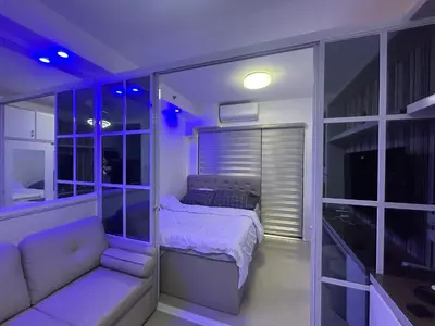 a small bedroom with a bed and a couch at E&T staycation in Manila