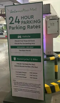a sign for a hour parking parking rates at 2BR Condo in Makati- Good for 6! in Manila