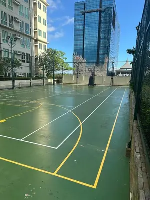 an empty tennis court in the middle of a city at 2BR Condo in Makati- Good for 6! in Manila