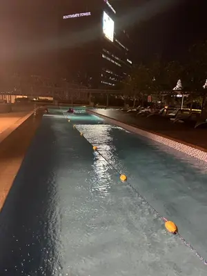 a swimming pool at night in a city at 2BR Condo in Makati- Good for 6! in Manila