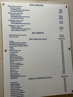 a white menu on a wall in a bathroom at 2BR Condo in Makati- Good for 6! in Manila