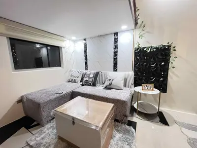 a small bedroom with a bed and a window at Loft life Staycation in Manila
