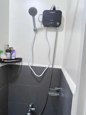 a blow dryer is attached to the wall of a bathroom at Loft life Staycation in Manila