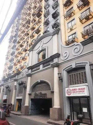 a building on a city street next to a tall building at Capsule park avenue in Manila