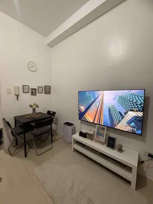 a living room with a large flat screen tv on a wall at Shore Residences 1BR Staycation in Manila