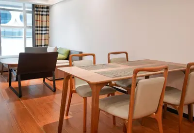 a dining room with a table and chairs at Grand Marina Residences in Manila