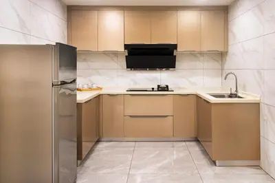 a kitchen with a refrigerator and a sink at Grand Marina Residences in Manila