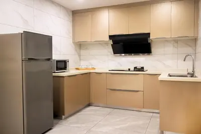 a kitchen with a refrigerator and a microwave at Grand Marina Residences in Manila