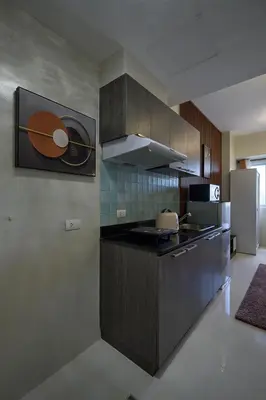 a kitchen with a stove and a refrigerator at Vista Blooms Stay at Vista Shaw with WiFi in Manila